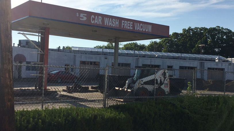 The first phase of a demolition of a former car wash has started as part of a three-way deal that will bring a Kettering Health Network office building to West Carrollton. NICK BLIZZARD/STAFF