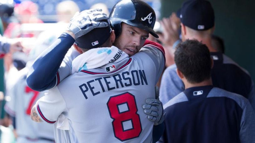Freddie Freeman of the Atlanta Braves hugs Jace Peterson after hitting a two run home run in the top of the first inning against the Philadelphia Phillies at Citizens Bank Park on August 30, 2017 in Philadelphia, Pennsylvania.