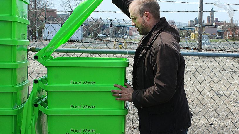 Econopia owner adjusts containers that will bring discarted food to his composting site. JEFF GUERINI/STAFF