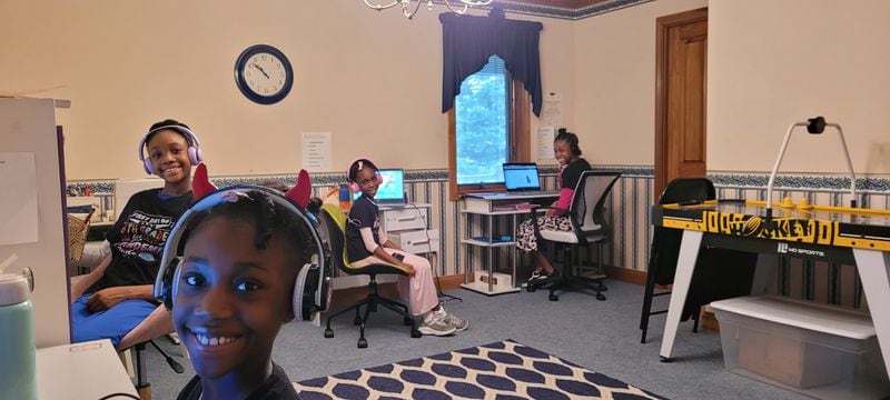 Victoria Parris' four daughters at their desks in their classroom: (left to right) Vivienne, Vanessa, Va'Lynzia and Va'Laurie.  Contributed