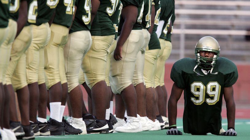Dayton’s Colonel White’s Bobby Martin moves behind teammates as they line up on the field prior to a game vs. Dunbar in 2005. Despite being born without legs, Martin played defensive line, keeping up with and taking down two-legged players twice his size. Jim Witmer/DDN FILE