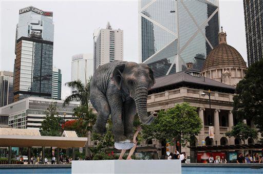 Statue of man balancing elephant