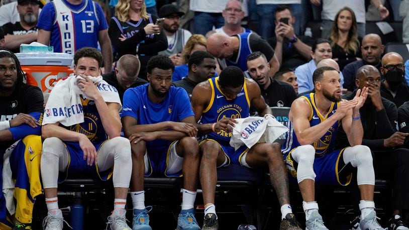 Golden State Warriors guards Klay Thompson, second from left, and Stephen Curry, second from right, sit on the bench during the second half of the team's NBA basketball play-in tournament game against the Sacramento Kings, Tuesday, April 16, 2024, in Sacramento, Calif. (AP Photo/Godofredo A. Vásquez)