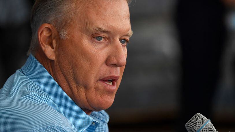 Denver Broncos President John Elway said his team wants to "take the politics out of football." The squad will stand together before  Sunday's game in Denver against the Oakland Raiders.