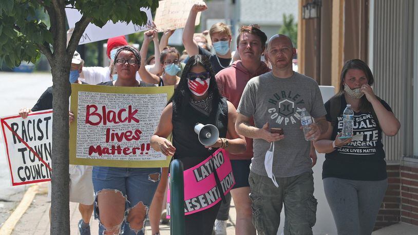 Black Lives Matter demonstrators march through New Carlisle Saturday. BILL LACKEY/STAFF