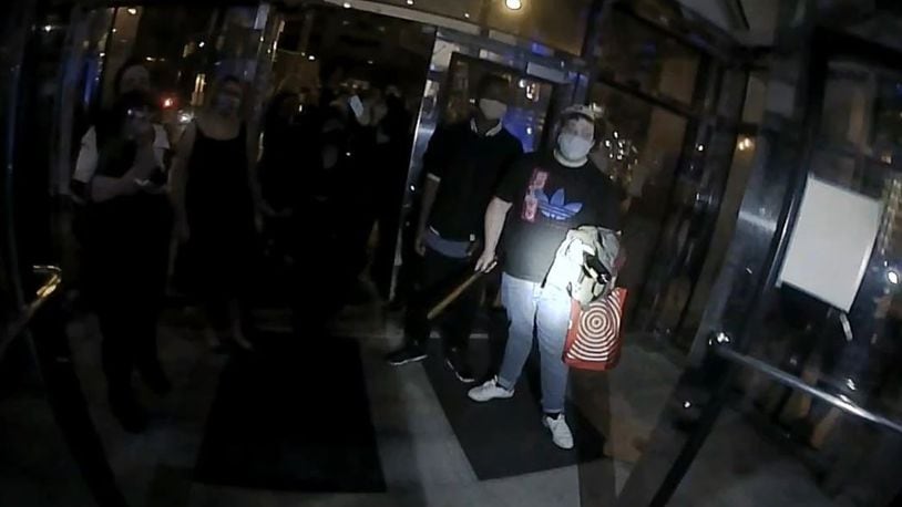 Columbus police released images from a breach of its headquarters and a man holding what they described as a club who is accused of assaulting an officer Tuesday night, April 13, 2021.