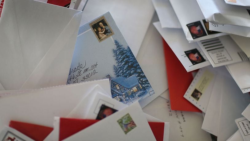 MIAMI, FL - DECEMBER 14:  A holiday card is seen among letters at the Processing and Distribution Center on the busiest mailing day of the year for the U.S. Postal Service on December 14, 2015 in Miami, Florida. With 10 days to go until Christmas eve, today the postal service was expecting 612 million pieces of mail to be sent, from first class letters to priority packages.  (Photo by Joe Raedle/Getty Images)