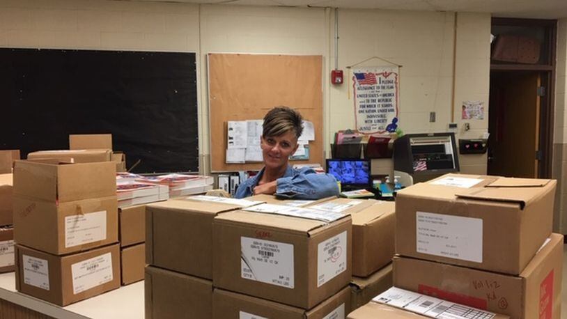 Leslie Renner, secretary in the Enon Primary office works behind boxes of school supplies as she preparees for the start of school. PAM COTTREL/CONTRIBUTED