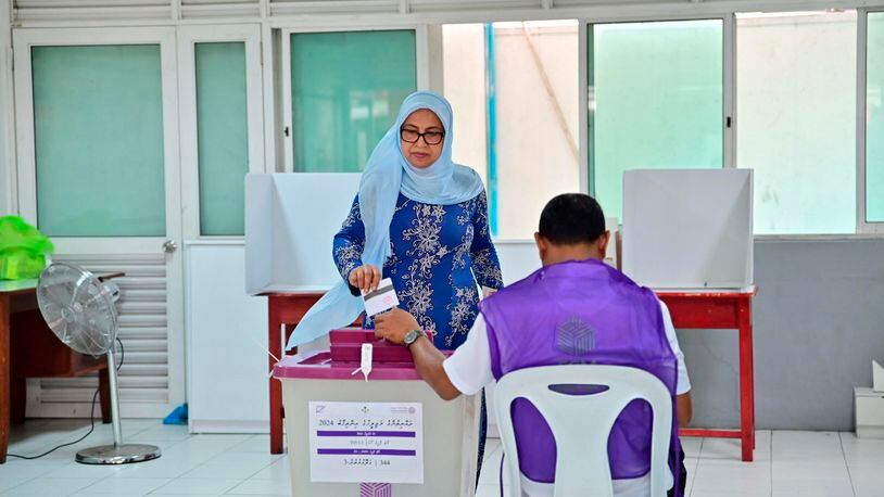 A woman casts her vote at a polling station in Male, India, Sunday, April 21, 2024. Maldivians are voting in parliamentary elections, in a ballot crucial for President Mohamed Muizzu, whose policies are keenly watched by India and China as they vie for influence in the archipelago nation. (AP Photo/Mohamed Sharuhaan)