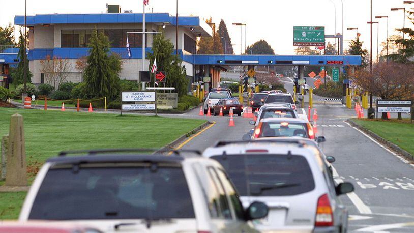 Vehicles line up to enter the United States at the border crossing between Blaine, Washington and White Rock, British Columbia November 8, 2001 in White Rock, BC.