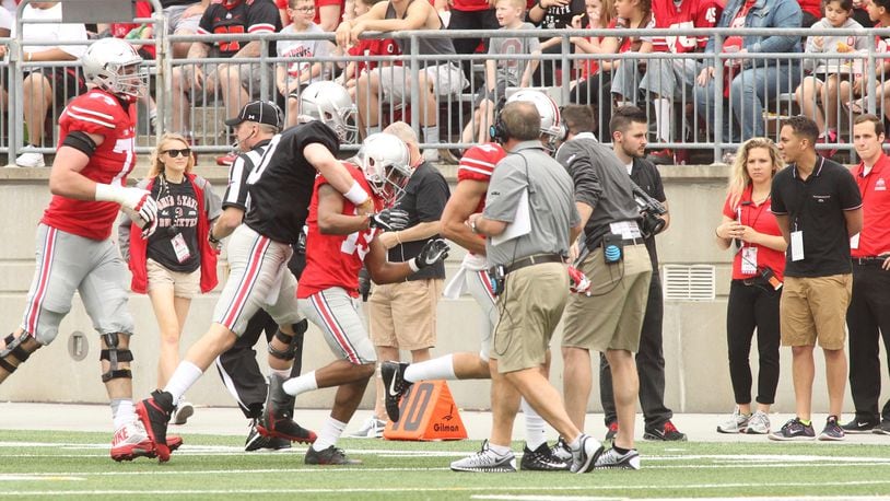 Joe Burrow congratulates Ke’Von Huguely after the two connected on a touchdown in the first half of the spring game on Saturday, April 15, 2017, at Ohio Stadium in Columbus. David Jablonski/Staff
