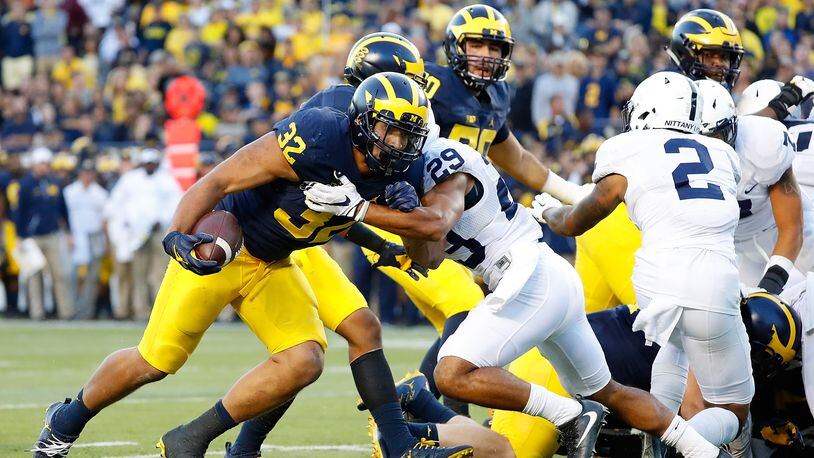 ANN ARBOR, MI - SEPTEMBER 24: Ty Isaac #32 of the Michigan Wolverines runs the ball in for a fourth quarter touchdown during the game against the Penn State Nittany Lions at Michigan Stadium on September 24, 2016 in Ann Arbor, Michigan. Michigan defeated Penn State 49-10. (Photo by Leon Halip/Getty Images)