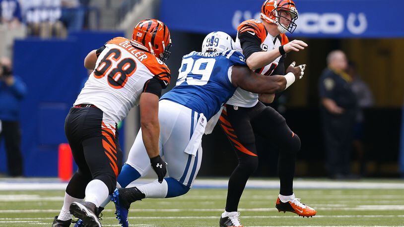 INDIANAPOLIS, IN - OCTOBER 19: Ricky Jean Francois #99 of the Indianapolis Colts slips past Kevin Zeitler #68 of the Cincinnati Bengals to hit Andy Dalton #14 of the Cincinnati Bengals during the third quarter on October 19, 2014 at Lucas Oil Stadium on October 19, 2014 in Indianapolis, Indiana. Indianapolis defeated Cincinnati 27-0. (Photo by Kirk Irwin/Getty Images)