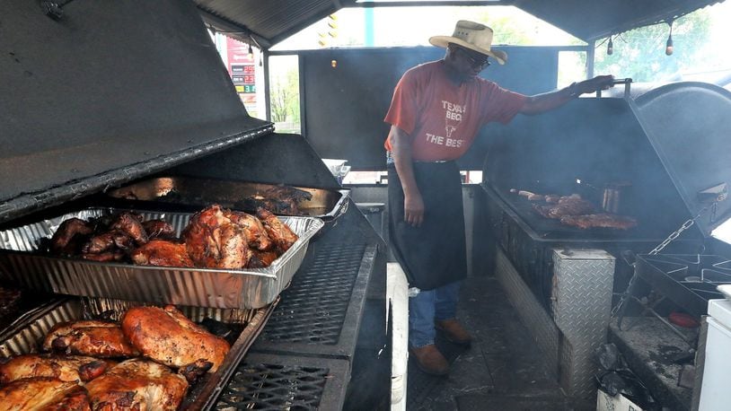 Richard Riddle, owner of Riddle's Ribs/Texas Cowboy Barbaque, mans the grills at his outdoor stand. Bill Lackey/Staff