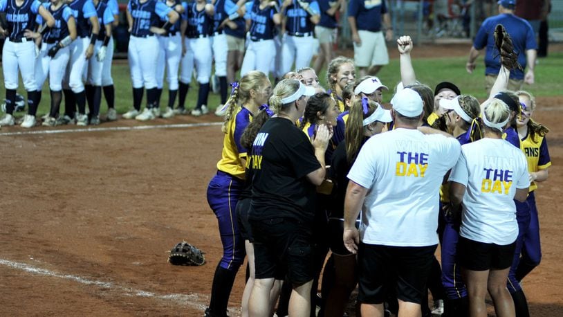 The Mechanicsburg players and coaches celebrate Friday night after defeating Jeromesville Hillsdale 7-3 in a Division IV state softball semifinal at Firestone Stadium in Akron. RICK CASSANO/STAFF