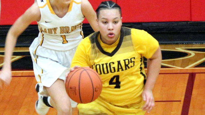 Kenton Ridge senior Desiree Jones (4) combined with junior teammate Kirsten Wiley to score the Cougars’ final five points in a 42-40 Division II sectional defeat of Shawnee on Thursday. GREG BILLING / CONTRIBUTED