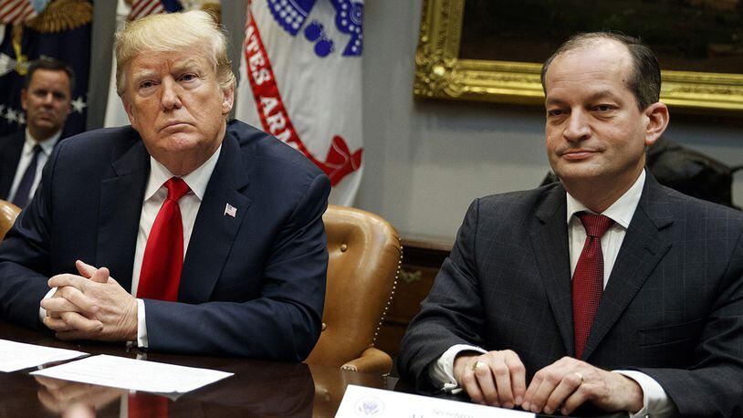In this Sept. 17, 2018, file photo, President Donald Trump, left, and Labor Secretary Alexander Acosta listen during a meeting of the President's National Council of the American Worker in the Roosevelt Room of the White House in Washington.
