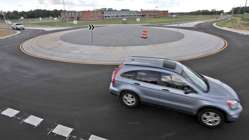 Clark County traffic navigates the new roundabout at the intersection of Selma and Possum Roads in front of Shawnee Schools Tuesday, August 30, 2022. BILL LACKEY/STAFF