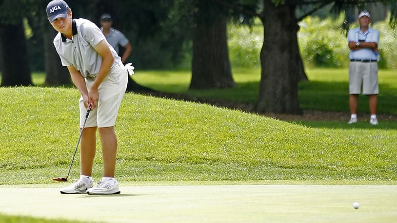 Luke Wells, a 16-year-old Springfield High School student, watches his putt roll across the third green during the second round of the Ohio Amateur at the Springfield Country Club on Wednesday. BILL LACKEY / STAFF