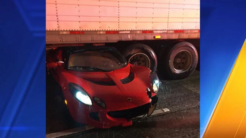 A pricey exotic sports car hydroplaned and slid into a semitruck that was carrying a load of fish Friday night, the Washington State Patrol said. (Washington State Patrol)