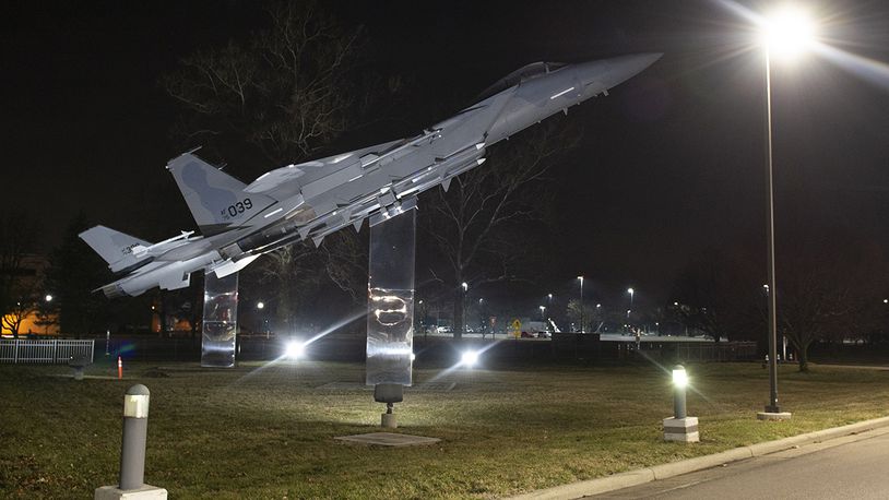 The two fighter aircraft on static display next to Gate 12A are lit up the night of March 16 at Wright-Patterson Air Force Base. U.S. AIR FORCE PHOTO/WESLEY FARNSWORTH