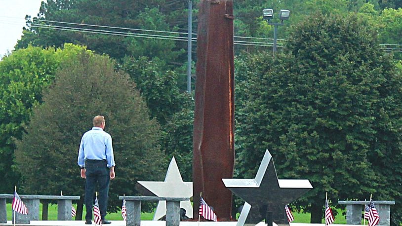 A man pays his respect at the 9/11 Memorial in Freedom Grove to honor the victims who died that day. JEFF GUERINI/STAFF