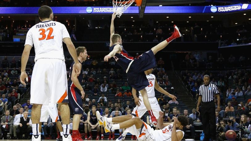CHARLOTTE, NC - MARCH 20: Evan Bradds #35 of the Belmont Bruins falls at the basket against the Virginia Cavaliers during the second round of the 2015 NCAA Men’s Basketball Tournament at Time Warner Cable Arena on March 20, 2015 in Charlotte, North Carolina. (Photo by Bob Leverone/Getty Images)