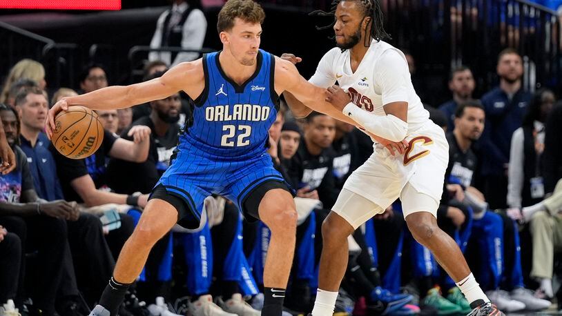 Orlando Magic forward Franz Wagner (22) makes a move against Cleveland Cavaliers guard Darius Garland, right, during the first half of Game 4 of an NBA basketball first-round playoff series, Saturday, April 27, 2024, in Orlando, Fla. (AP Photo/John Raoux)