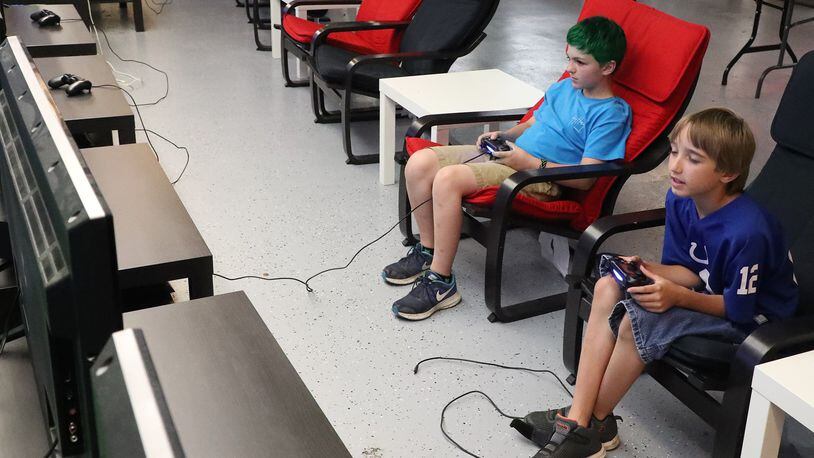 Cale Wheeler, left, and Elijah Clicquennoi play video games Thursday, May 31, 2018 at Pixel Playground in the Upper Valley Mall. Bill Lackey/Staff