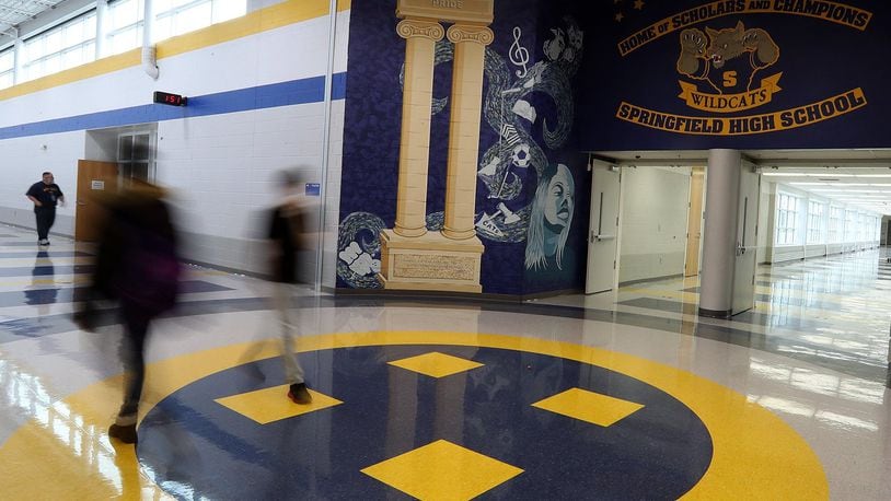 Students walk through the atrium of Springfield High School. Springfield city schools are at risk of not graduating about 40 percent of its students if Ohio does not change its graduation requirement. BILL LACKEY/STAFF