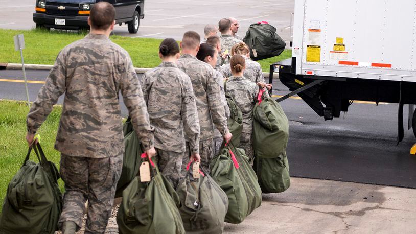 FILE: Airmen load their mobility bags onto a waiting cargo truck after processing through the mobility bag issue line as part of a base exercise at Wright-Patterson Air Force Base in 2015. (U.S. Air Force photo by Wesley Farnsworth/Released)