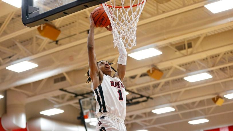 Wayne High School junior Lawrent Rice dunks the ball during a game against Springfield on Tuesday night in Huber Heights. The Warriors won 82-65. CONTRIBUTED PHOTO BY MICHAEL COOPER