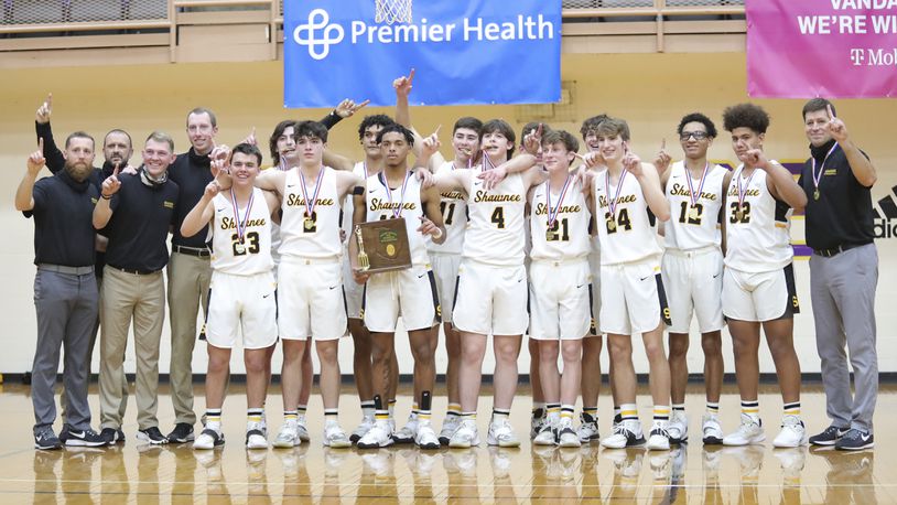 The Shawnee High School boys basketball team celebrates after winning its first district title since 1977. Michael Cooper/CONTRIBUTED