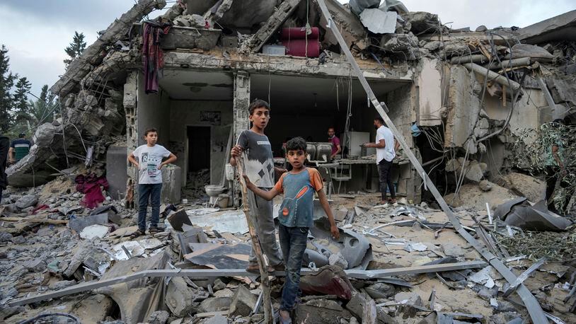 Palestinians look at the destruction after an Israeli airstrike in Deir al Balah, Gaza Strip, Tuesday, April 30, 2024. (AP Photo/Abdel Kareem Hana)