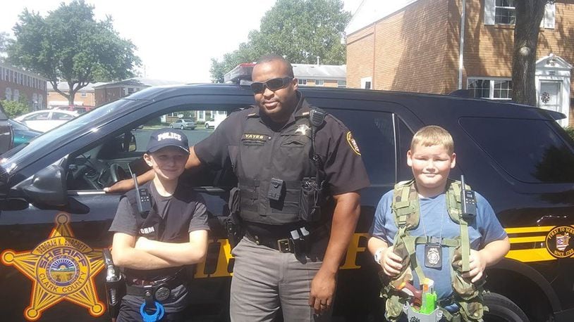 (left to right) Storm Pelfrey, Deputy Matthew Yates, and Eddie Strayer stand in front of Yates' cruiser after a surprise visit.