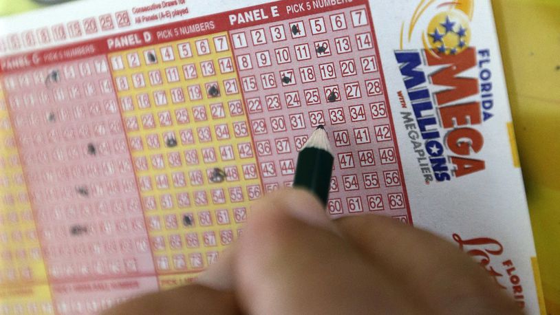A customer fills out a Mega Millions ticket at a local grocery store, Friday, July 1, 2016, in Hialeah, Fla. Friday night's Mega Millions drawing will give lottery players a shot at the 10th largest jackpot in U.S. history. (AP Photo/Alan Diaz)
