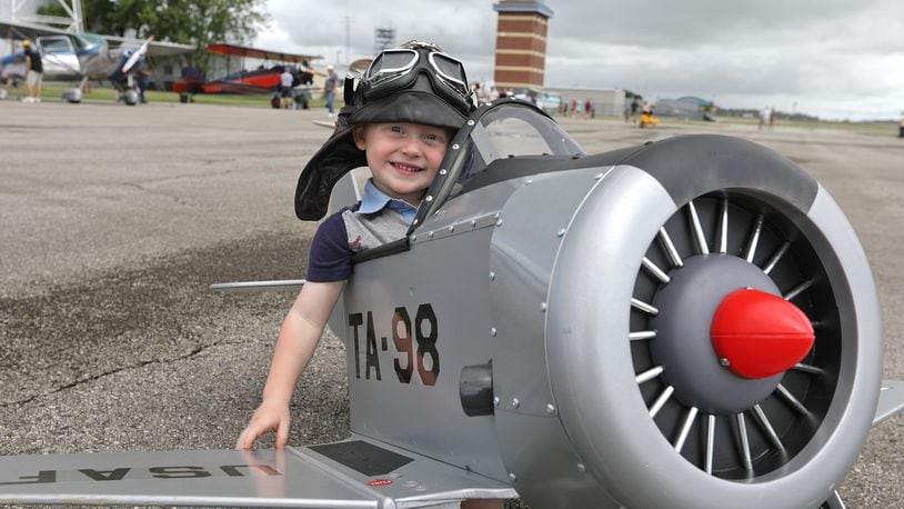 Winfield Dixon, 3, was pretending to be a flying ace in a pedal plane Saturday at the 2021 Barnstorming Carnival at the Springfield Beckley Airport. BILL LACKEY/STAFF