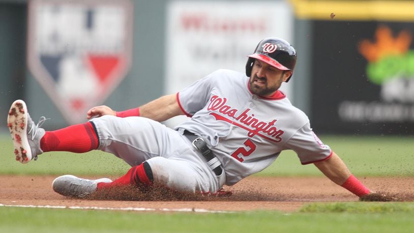 The Nationals’ Adam Eaton slides into third base against the Reds on Opening Day on Friday, March 30, 2018, at Great American Ball Park in Cincinnati. David Jablonski/Staff