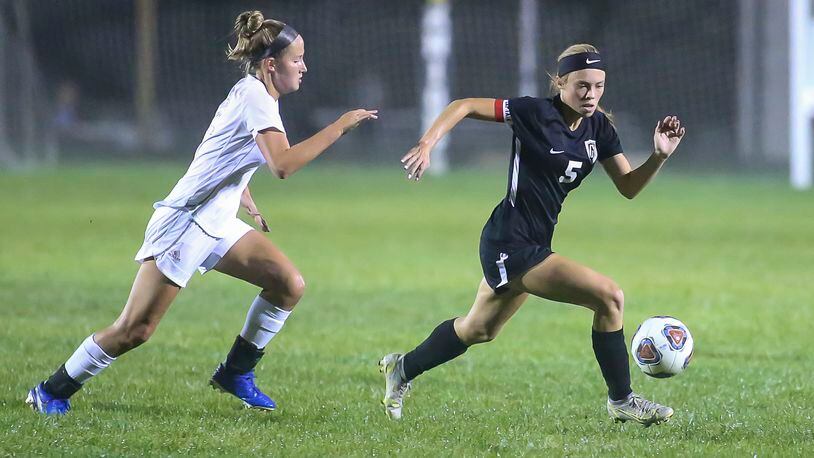 Cutline: Greenon High School senior Hallie Gilley and Catholic Central junior Emily DeWitt run after the ball during their game on Monday night at Greenon Stadium. The Knights won 5-0. CONTRIBUTED PHOTO BY MICHAEL COOPER
