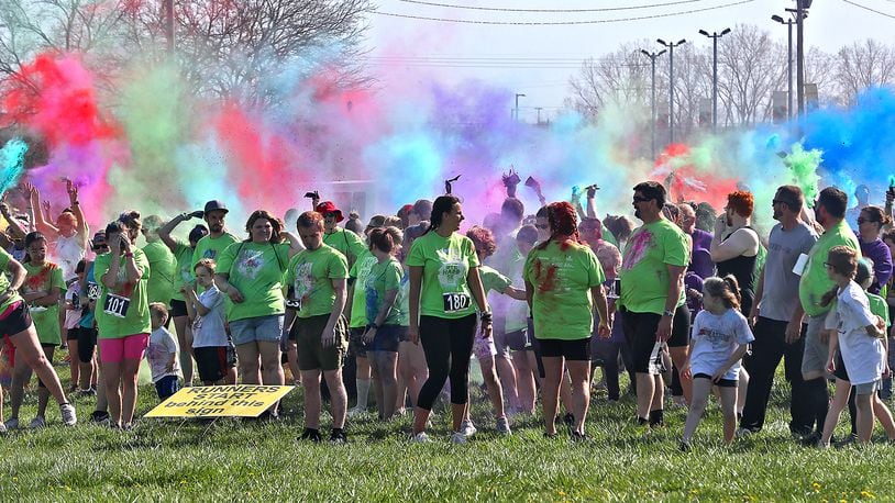 Clark County's most colorful benefit, the Dye Hard 5K Race/Walk was held Sunday, April 24, 2022 at the Clark County Fairgrounds. Hundreds of people participated in the annual event that benefits people with developmental desabilties. As runners and walkers made their way around the course colorful powder was thrown on them at different stations. BILL LACKEY/STAFF