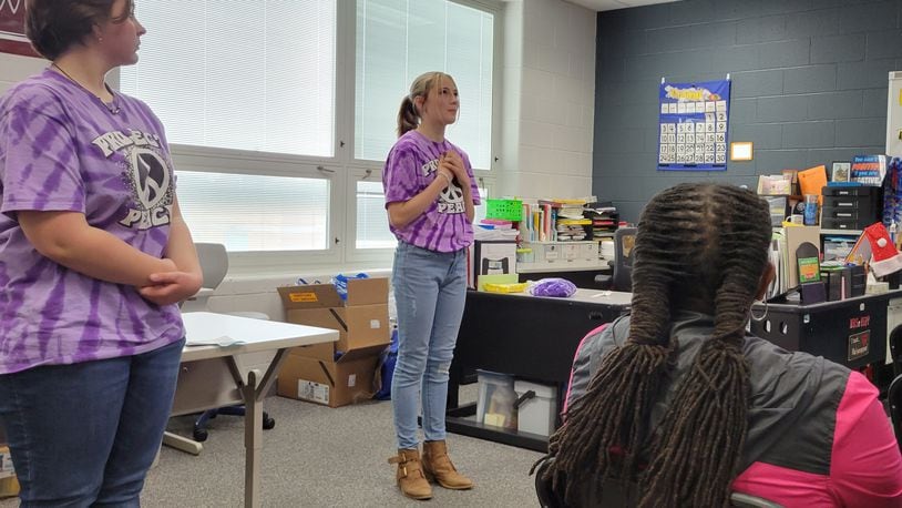 Schaefer Middle School students Kairi Krauss, center, and Gabrielle Shoemaker speak to guests on how gun violence is affecting Springfield students during a presentation at the school on Friday, April 29. Several students formed a group called Project Peace to counter the problem.