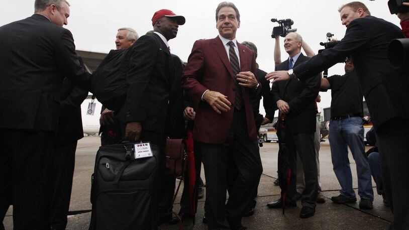 Alabama coach Nick Saban arrives with his team at Louis Armstrong New Orleans International Airport on Saturday, Dec. 27, 2014, in New Orleans. David Jablonski/Staff