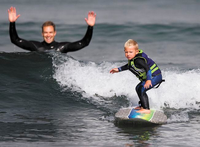 IMAGES: Surfing 3-year-old turning heads on Central Coast beach