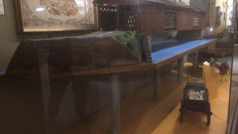 This bridge model at the Heritage Center represents an 1837 bridge that was the last federally funded bridge built on the National Road. The model was made from 1,700 pieces of salvaged wood from the original, which was removed in 1926 and replaced in 1928. The connecting pins that held the original bridge together were made by Mrs. Christine (Doctor) Herr of Donnelsville who had a five year contract from the U.S. Government to make wooden pins for bridges on the National Road. PHOTO COURTESY OF THE CLARK COUNTY HISTORICAL SOCIETY