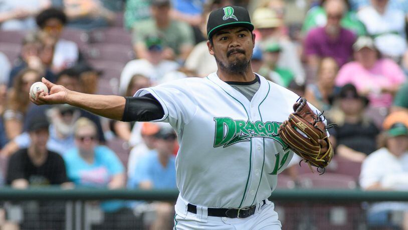 Dragons pitcher Tony Santillan throws to first base during the fourth inning of a game against West Michigan on Monday at Fifth Third Field. Contriubted Photo / Bryant Billing