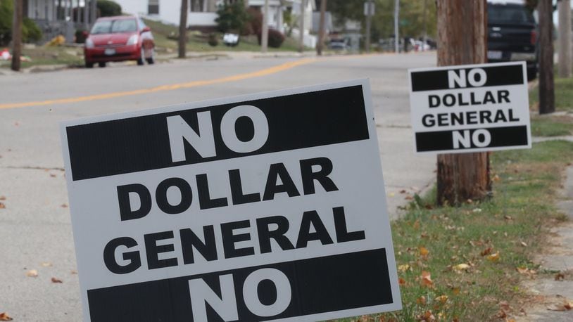 “No Dollar General” signs line Main Street in South Vienna as residents protest the proposed new business location. BILL LACKEY/STAFF