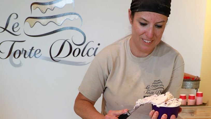 Lisa Freeman, owner of LeTorte Dolci, scoops out some gelato Friday in the bakery. To celebrate their one year anniversary, the bakery has started selling the cold, sweet treat. BILL LACKEY/STAFF