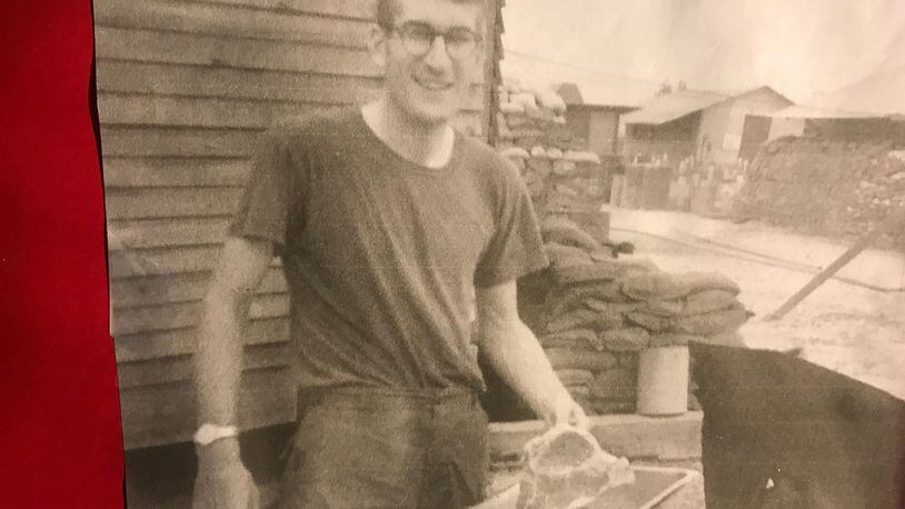 Jim Brown in Tay Nihn (Vietnam) camp on Cambodian border cooking a T-bone steak on Thanksgiving Day 1969. Sandbags on quarters in back, trying to protect camp from nightly onslaught of rockers and motars that came from Cambodia less than three miles away. CONTRIBUTED