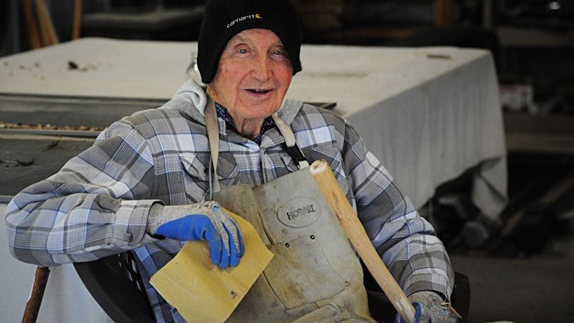 Retired 93-year-old Air Force Col. John Hobson, shown in the workshop Thursday, Dec. 10, 2020, where he lives with his son's family near Xenia, handcrafts walking sticks that he sells for $3 each to benefit the Xenia FISH Food Pantry. MARSHALL GORBY/STAFF