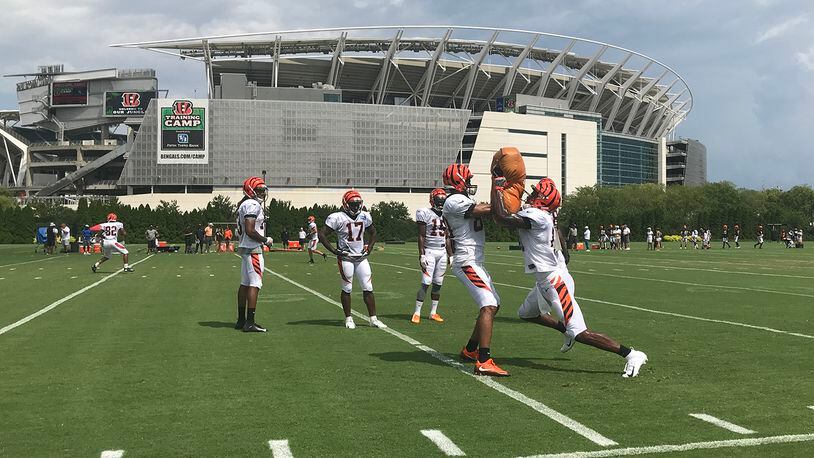 Cincinnati Bengals wide receiver and Lakota West graduate Kayaune Ross (right) goes through a blocking drill with Josh Malone during Monday’s practice at Paul Brown Stadium. JAY MORRISON/STAFF